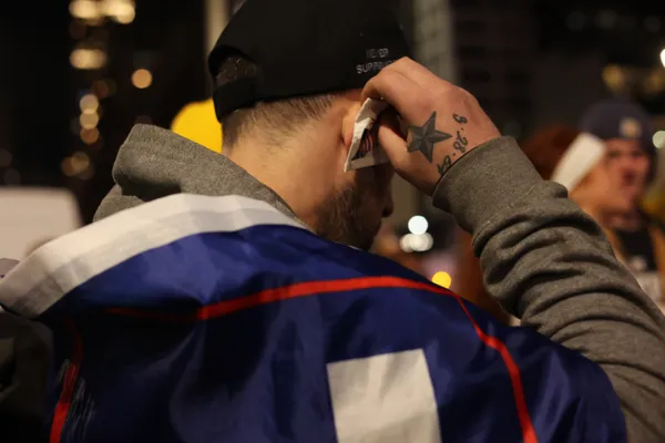 A man puts a faux bandage on his ear outside a Trump rally thumbnail