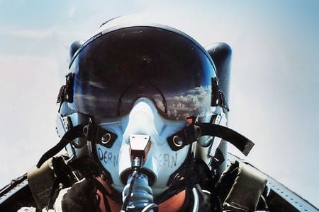 Selfie of Joy Dean in her flight helmet. Clouds are reflected in the visor.