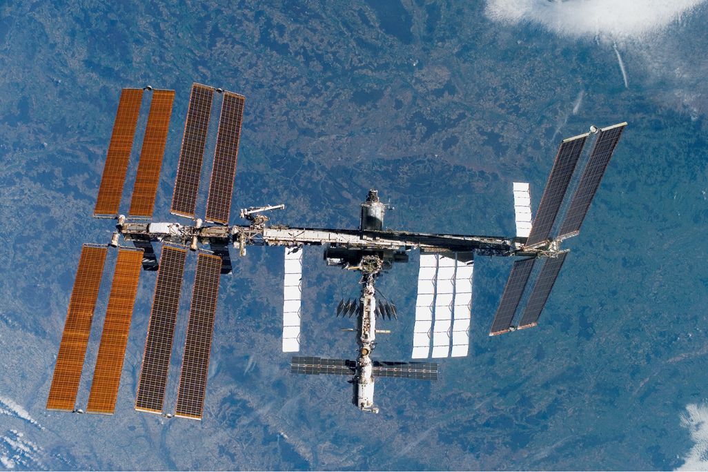An aerial view of the International Space Station, with Earth visible below