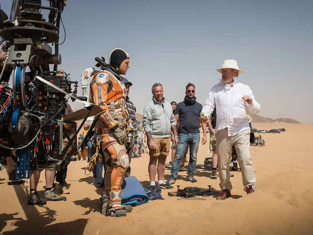 Damon and director Ridley Scott (far right) on location in Jordan (Aidan Monaghan:20th Century Fox).jpg