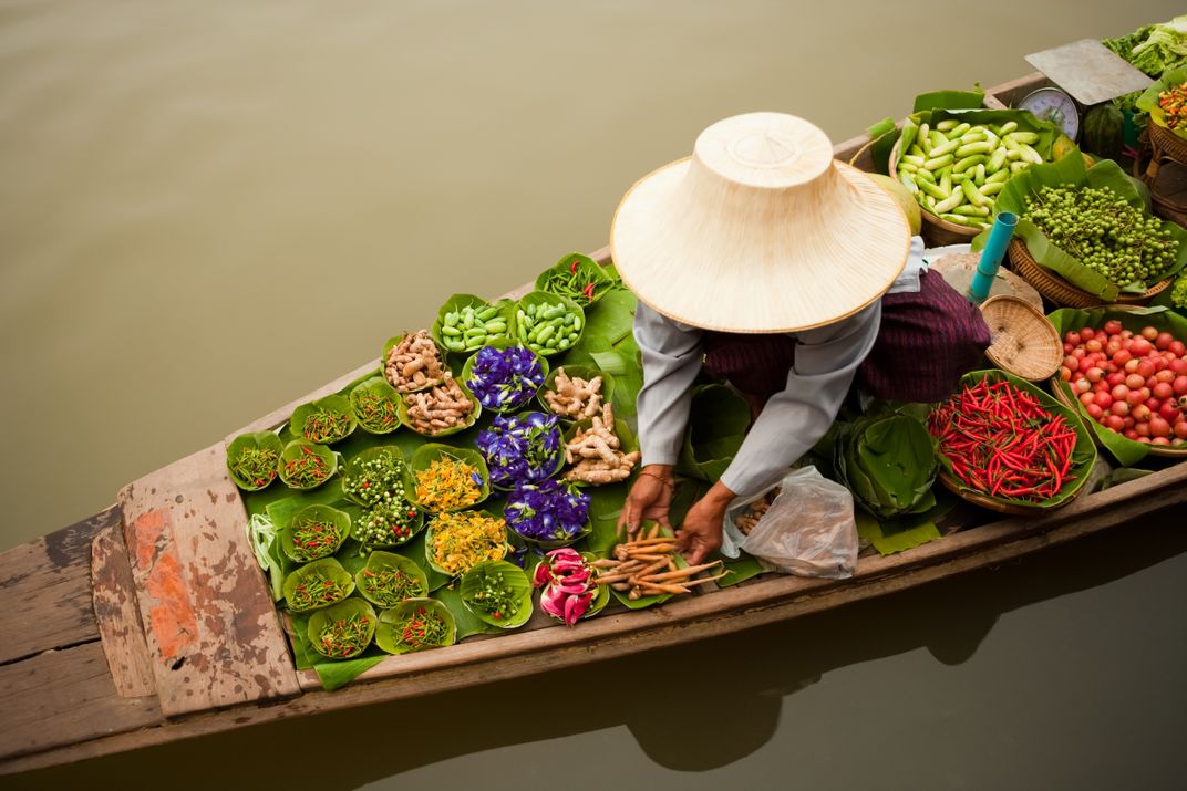 A vendor at a floating market in Bangkok