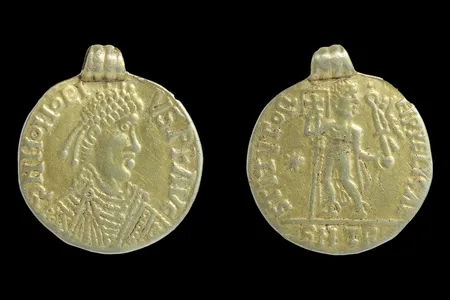 The coin features the bust of Honorius on one side. The other side depicts a person holding a&nbsp;banner or flag with a cross on it.