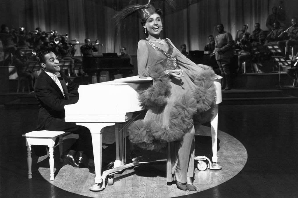 Lena Horne dancing in front of a piano