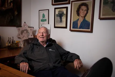 Mel Mermelstein sits in his California home