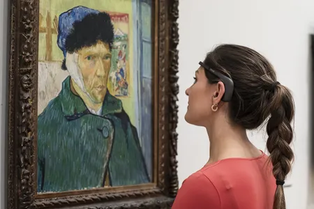 A museum visitor wears the new headset, which collects brainwave data that is used to create real-time images visualizing their response to art.
