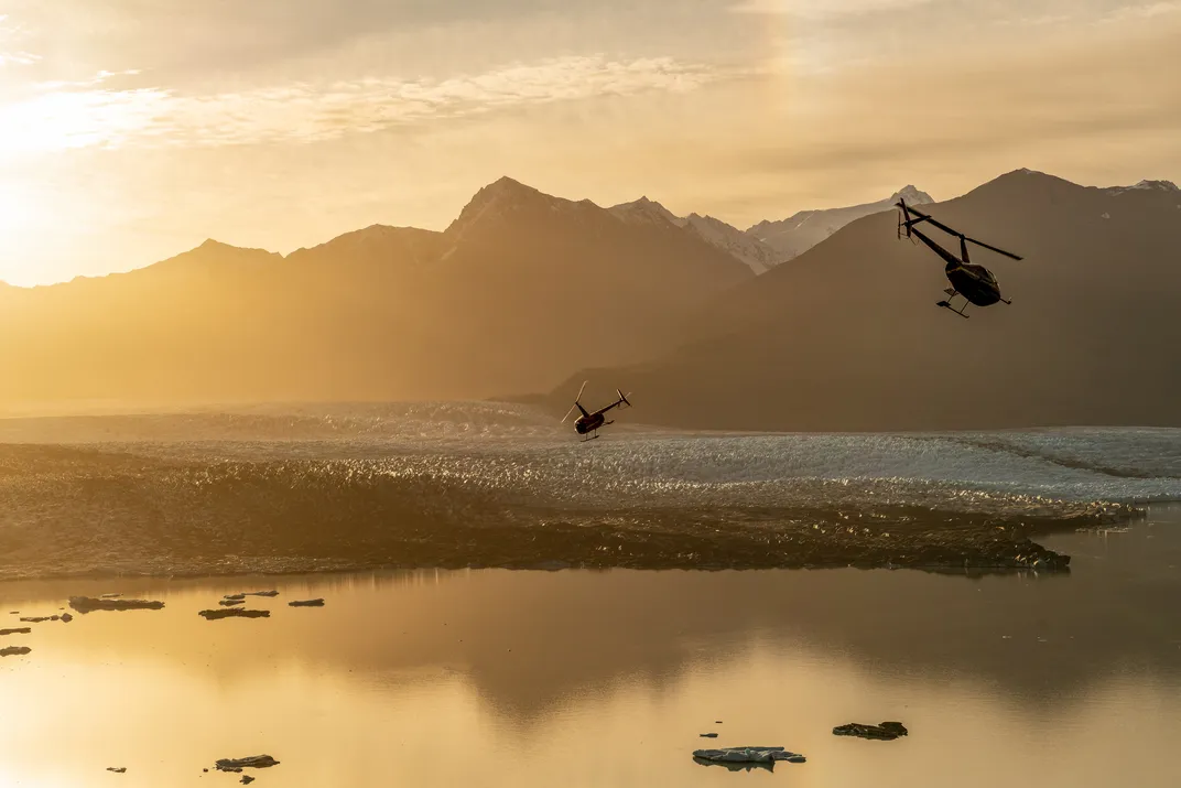 helicopters fly over Knik Glacier