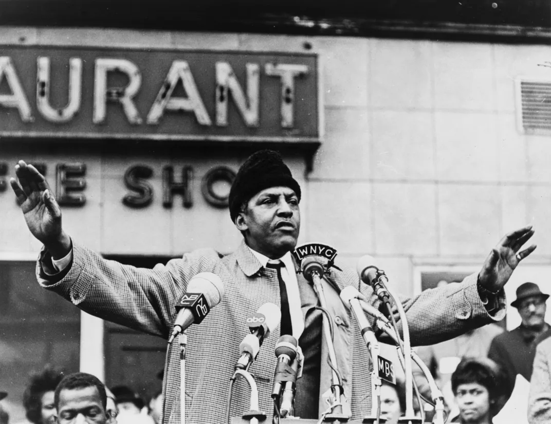 Rustin speaking in front of an audience in 1965