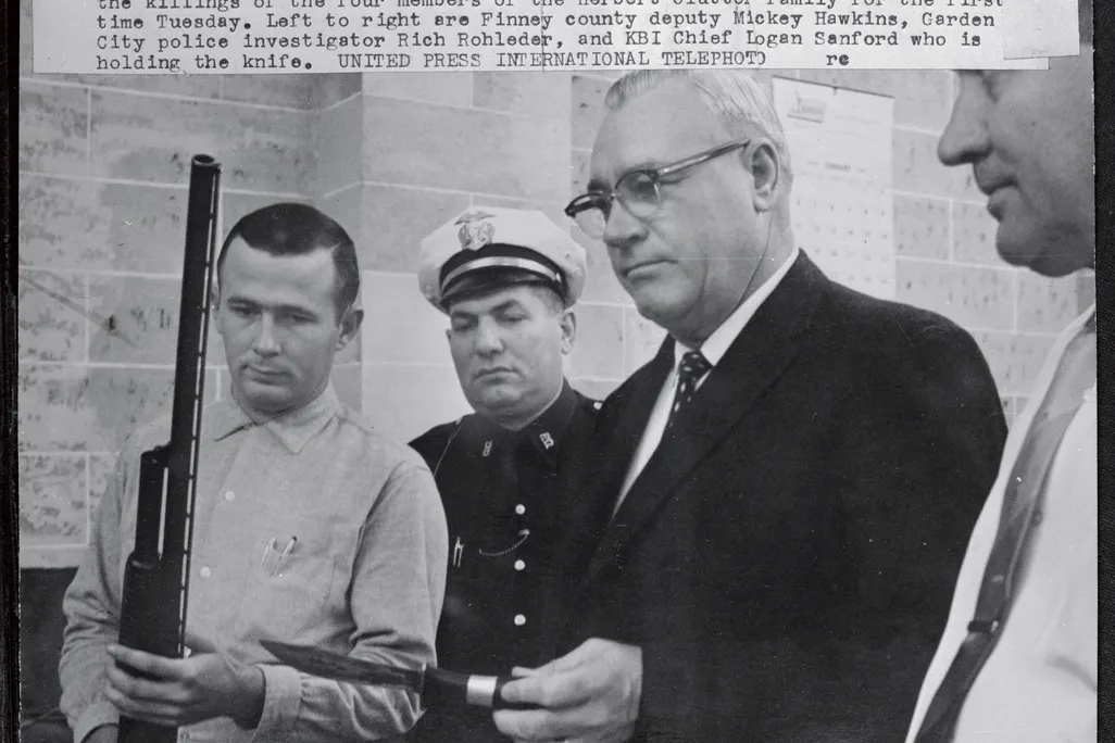 Officers display shotgun and knife used in the killings of the four members of the Herbert Clutter family