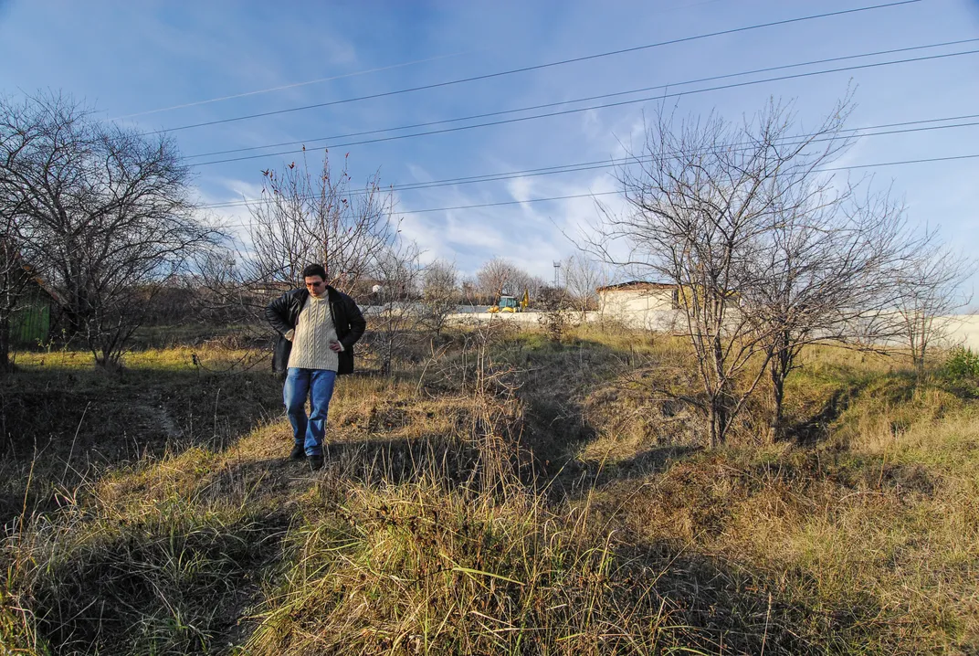 Vladimir Slavchev wanders through the cemetery’s overgrown brush