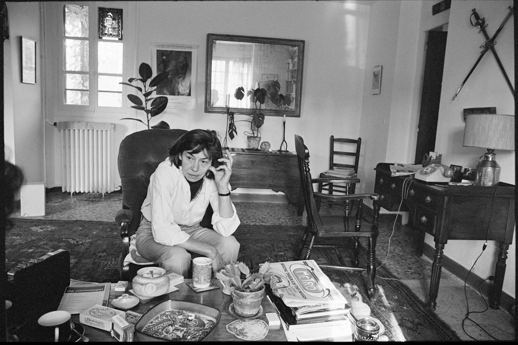 Portrait of American novelist Patricia Highsmith as she sits in the living room of her home in France.