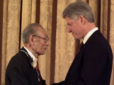 President Clinton presents Fred Korematsu with a Presidential Medal of Freedom during a ceremony at the White House Thursday, Jan. 15, 1998. Korematsu's legal challenges to civilian exclusion orders during World War II helped spur the redress movement for Japanese-Americans.