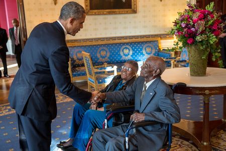 President Barack Obama greets Richard Overton, with Earlene Love-Karo, in the Blue Room of the White House, Nov. 11, 2013.