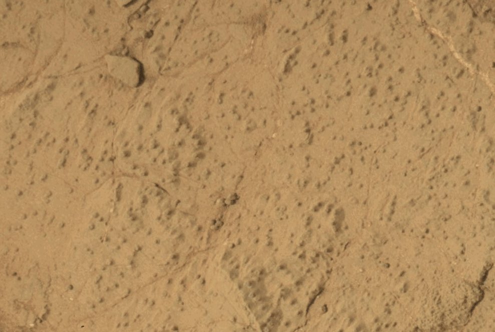 a gif shows martian ground followed by a hole drilled into it and surrounded by dust