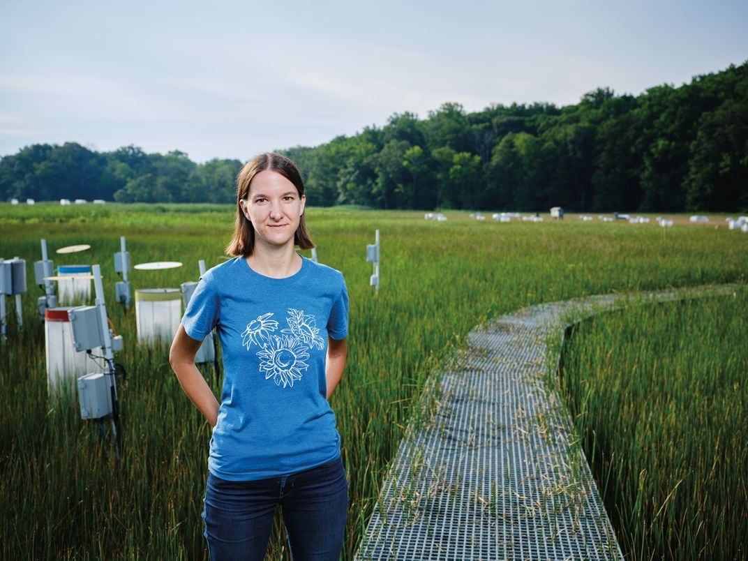 a person poses for a portrait in wetlands