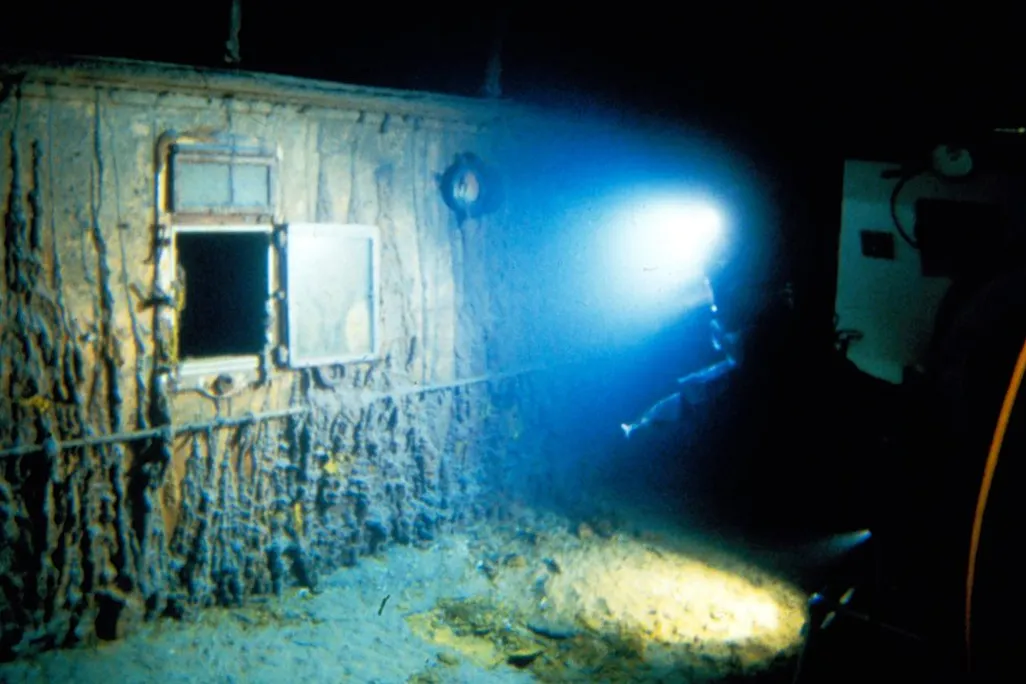 a light shines on a disintegrating ship