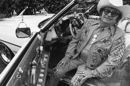 Designer Nudie Cohn sits in his Pontiac convertible.