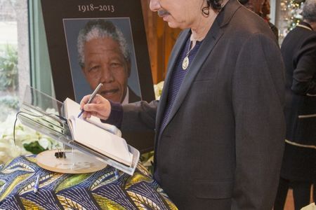 Music Great Carlos Santana signs a condolence book for Nelson Mandela on Dec. 6 at the National Museum of African Art.