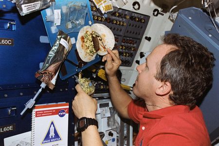 Tom Jones making a breakfast burrito in space. Meals are easier on the ground, and there’s more variety.
