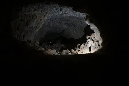 A researcher explores the depths of Umm Jirsan.