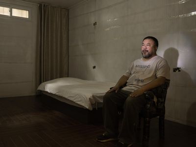 Ai sits in a replica of the prison cell in which he was detained in 2011. No one in China, he has said, "has a solid belief or trust in society."