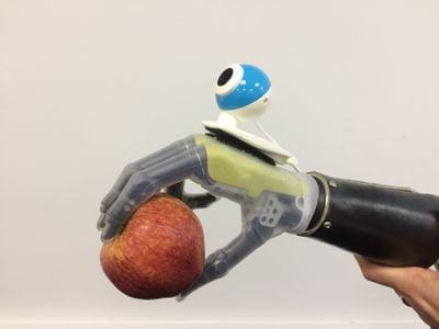 A prosthetic hand outfitted with an inexpensive webcam lets its user grab objects with less effort.
