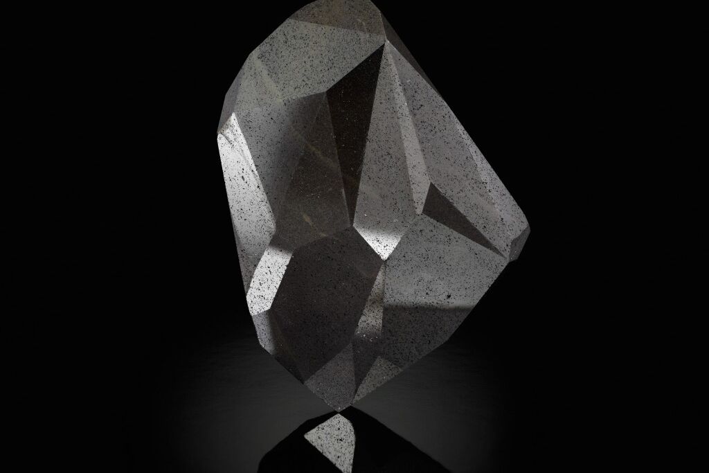 A large black gemstone with 55-facets