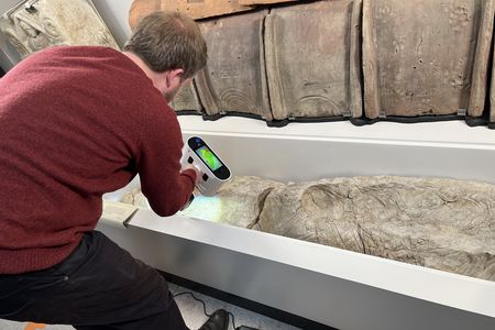 A researcher scans the negative cavity in the gypsum casing.