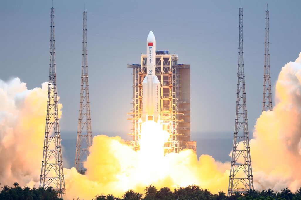 A photo of China's Long March 5B rocket blasting off into space. 