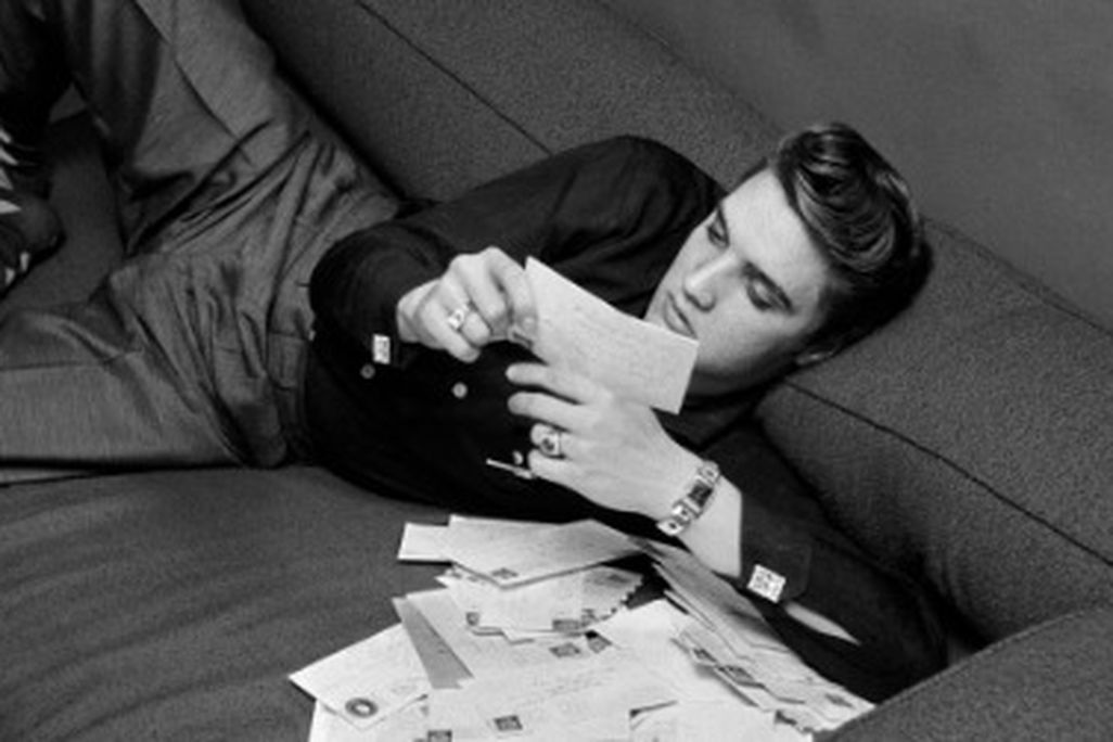 Elvis at 21: Presley reads fan mail on March 17, 1956