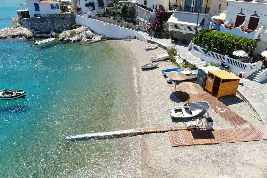 Blue water next to beach with wheelchair ramp