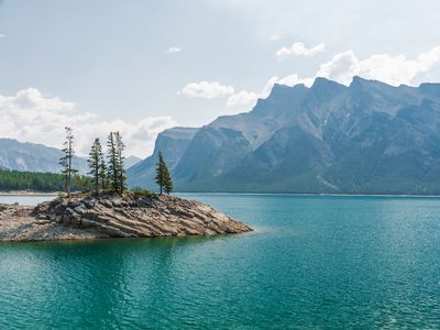 Beneath the surface of Lake Minnewanka, located in Alberta, Canada, rests the remains of a former resort town. 