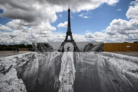 JR's newest illusion seemingly opens up a ravine in front of the Eiffel Tower.