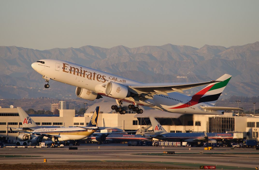 An Emirates 777-200LR leaves Los Angeles for Dubai, over 8,000 miles away. (flickr user InSapphoWeTrust)
