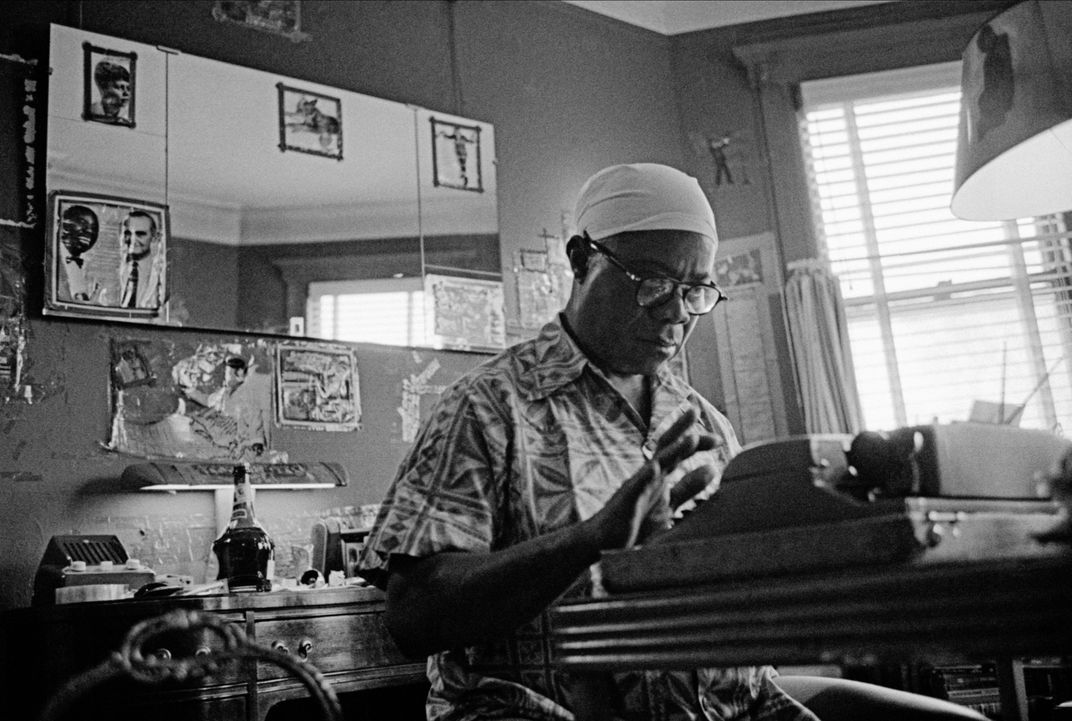 Louis Armstrong using a typewriter