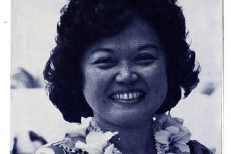 Patsy T. Mink wears a lei and smiles