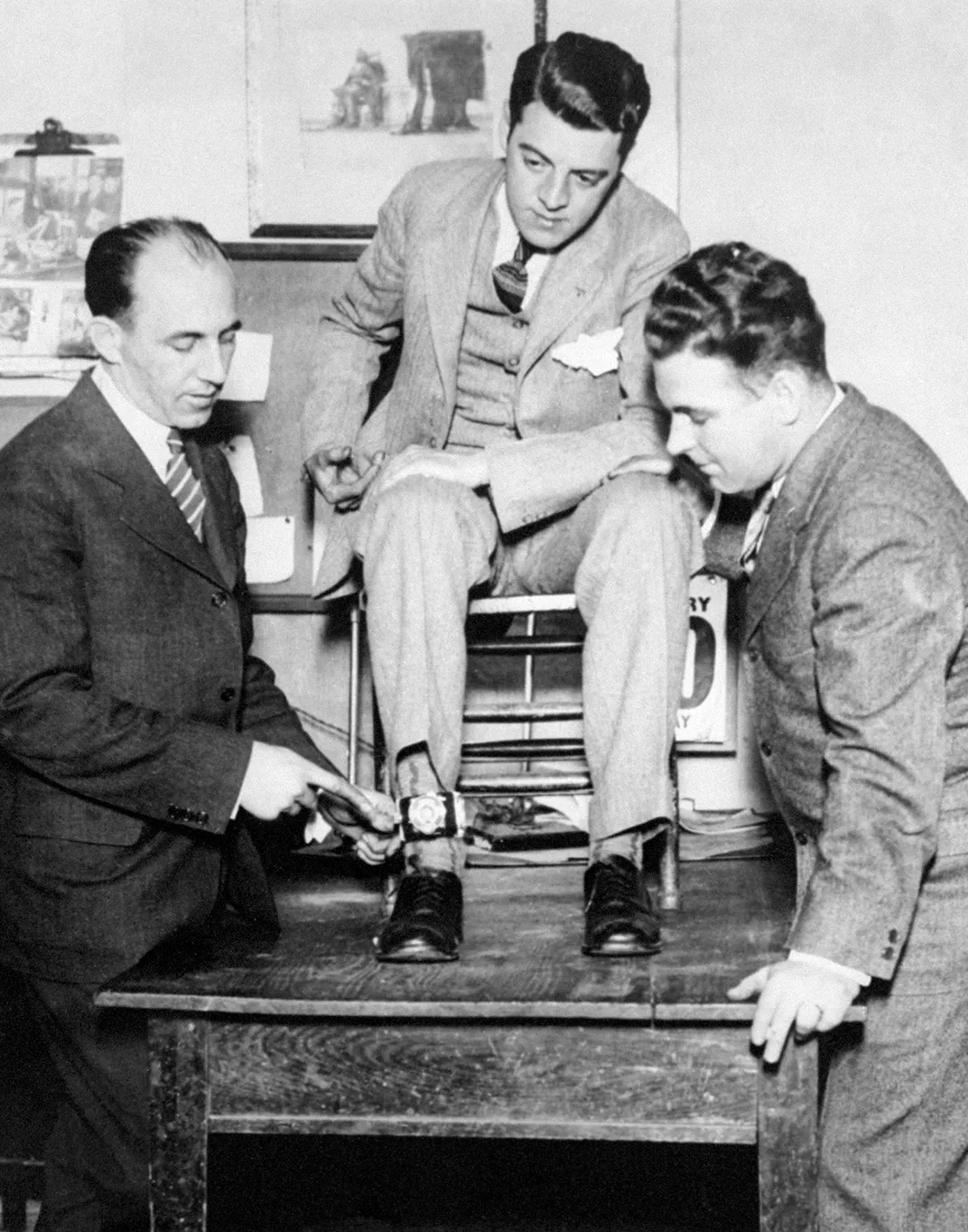 Photographer Tom Howard (seated) shows how he strapped a camera to his ankle to photograph Snyder's execution.