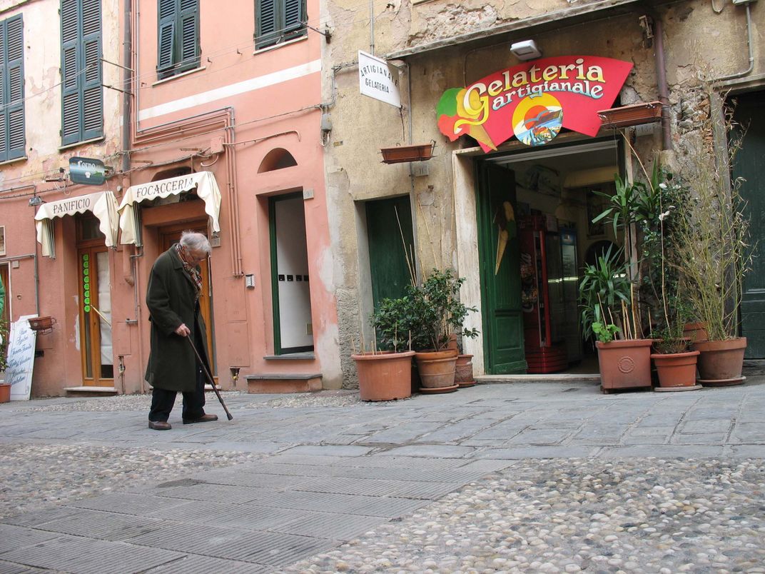 Elderly local in Cinque Terra Italy, in front of the local gelateria
