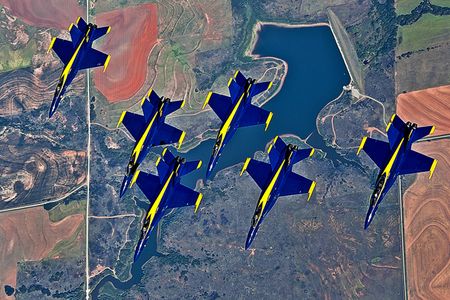 A formation of Navy Blue Angel FA-18 Hornets from Naval Air Station Pensacola, Fla., fly together after being refueled by a KC-135 Stratotanker from Altus Air Force Base Sept. 20, 2012. Aircrew from the 54th Air Refueling Squadron at Altus AFB refueled the Blue Angels on the way to Grand Juction, Colo., to perform in the First Mountain West Airshow. The Blue Angels travel 300 days out the year to perform aerial stunts for audiences nation wide.