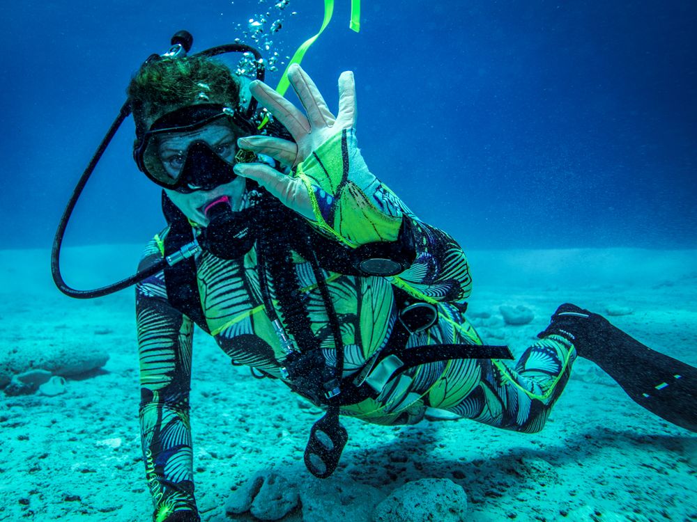 Underwater diver holding up something small