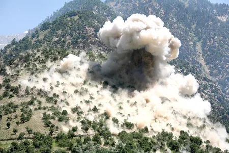 A bomb blast engulfs a mountainside near the town of Barg-e Matal in Afghanistan.