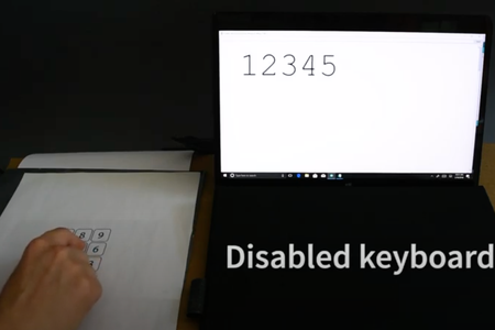 As the researcher taps the page, numbers appear on screen. 