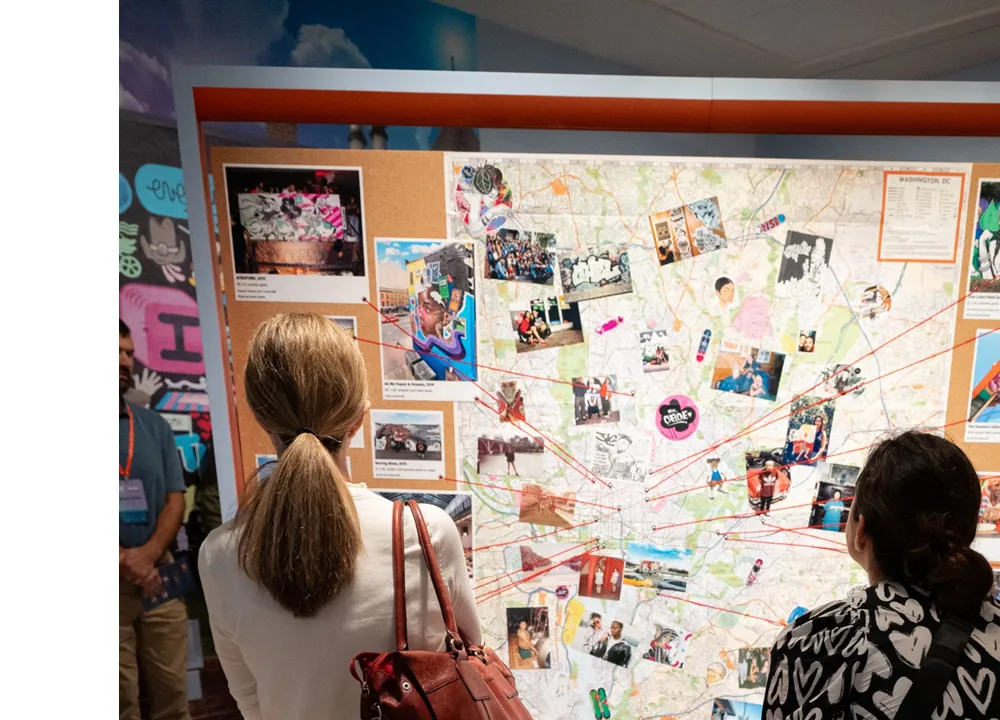 Educators gather around a map