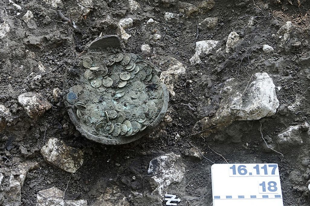 Coins in a clay pot