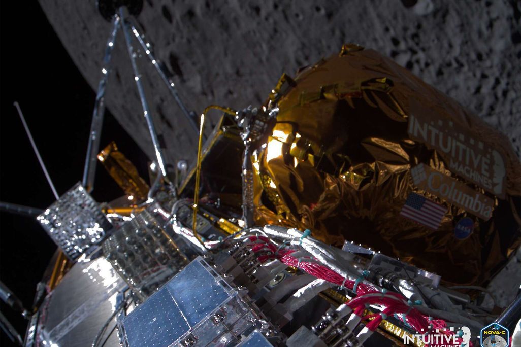 The side of a spacecraft with the surface of the moon in the background