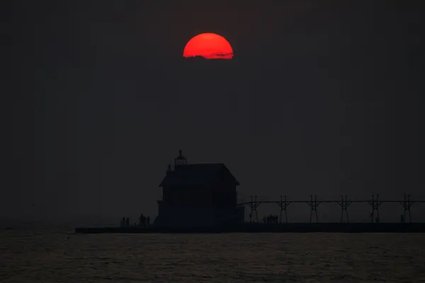 Grand Haven Lighthouse and Sun Setting during the 2025 Canadian Wildfires thumbnail