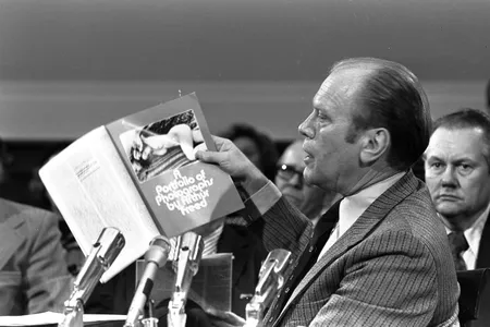 Vice President-designate Gerald Ford holds up a copy of Evergreen Review, a magazine which Ford described as obscene. One of Ford's charges against Douglas was that he had allowed an article he had written to be published in Evergreen.