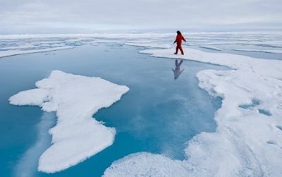 In this image from Science on Ice, graduate student Maria Tausendfreund collects a water sample from an Arctic melt pond during a brief period of 'ice liberty.'