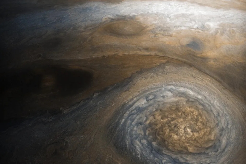 white and rust colored swirl in Jupiter's atmosphere