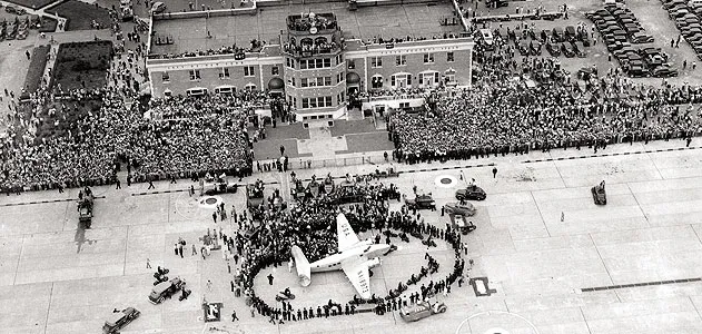 On July 14, 1938, thousands gathered for the return of Howard Hughes, who in four days had flown a Lockheed Super Electra around the world.