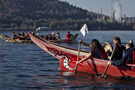 Members of the First Nation Tsleil-Waututh, Squamish and Musqueam bands paddle in traditional canoes during a Thanksgiving protest in North Vancouver, British Columbia October 14, 2013. The group are protesting the Trans Mountain Pipeline Expansion by energy company Kinder-Morgan and the increase of tanker traffic in the Burrard Inlet. 
